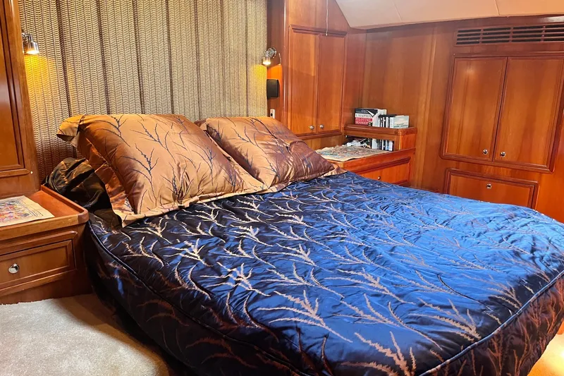 Slide: The Image of Luxurious bedroom interior of 2003 Pachoud Yachts Power Cat with elegant wood paneling. - 27