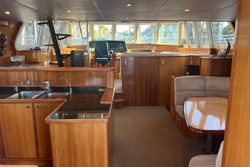 Slide: The Image of Luxurious 2003 Pachoud Yachts Power Cat interior with wood finishes and modern amenities. - 11
