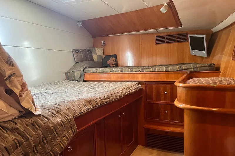 Slide: The Image of Luxurious cabin interior of 2003 Pachoud Yachts Power Cat with wood finish and cozy bedding. - 23