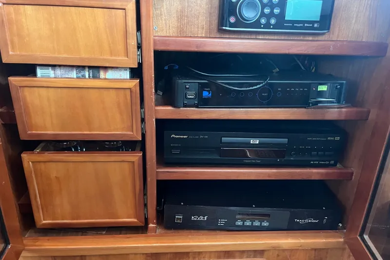 Slide: The Image of Wooden cabinet with audio-visual equipment on a 2003 Pachoud Yachts Power Cat. - 20
