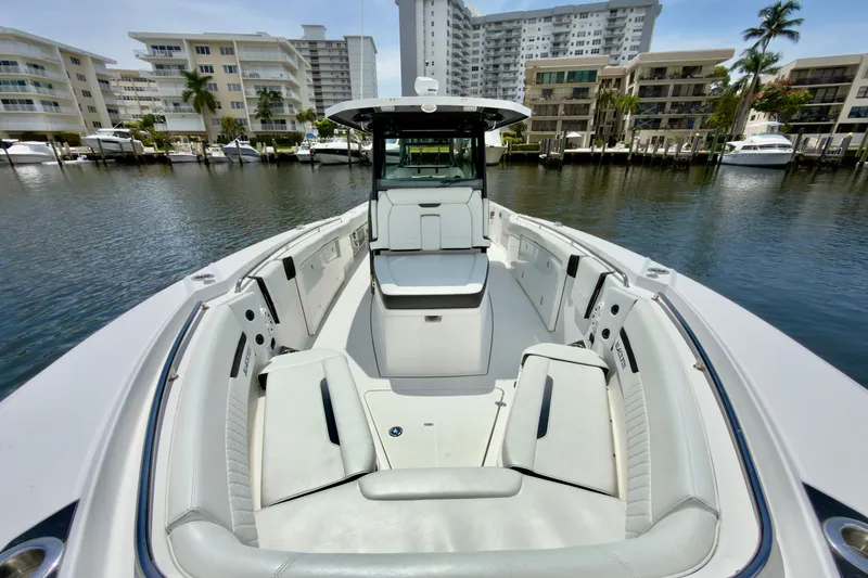 Slide: The Image of 2021 Blackfin 332 CC boat docked in marina, featuring spacious seating and modern design. - 28