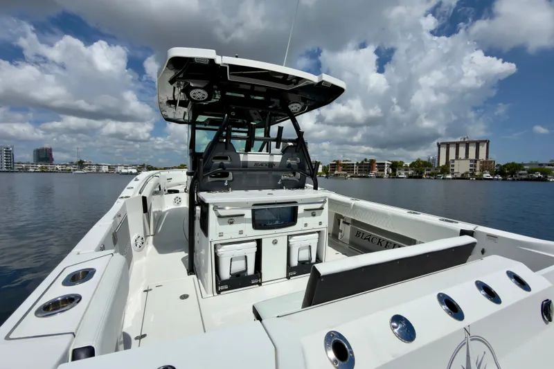 Slide: The Image of 2021 Blackfin 332 CC boat on water, featuring spacious deck and modern amenities. - 20