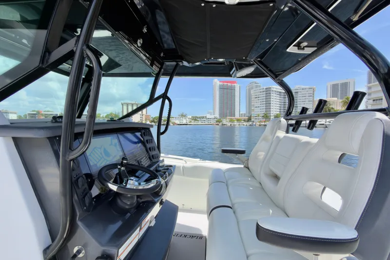 Slide: The Image of Interior view of a 2021 Blackfin 332 CC boat with city skyline in the background. - 24