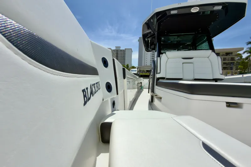 Slide: The Image of 2021 Blackfin 332 CC boat with sleek white seating and modern design. - 18