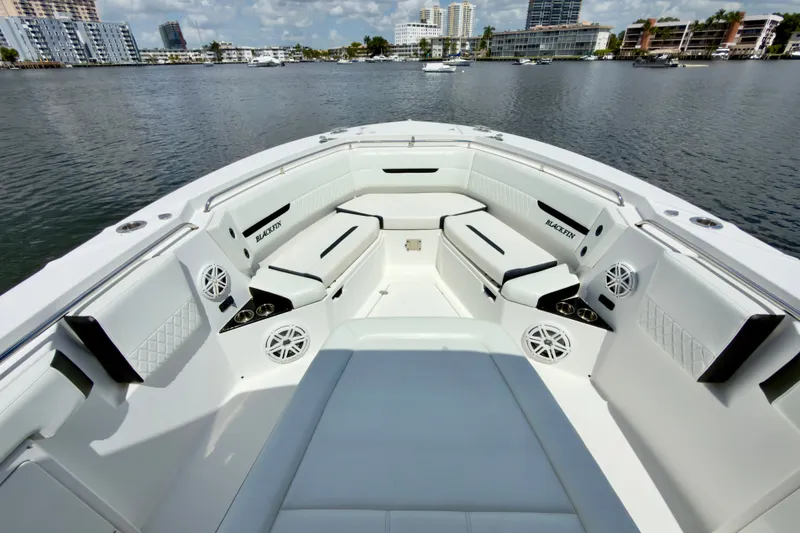 Slide: The Image of Luxurious seating area on a 2021 Blackfin 332 CC boat, docked by waterfront buildings. - 27