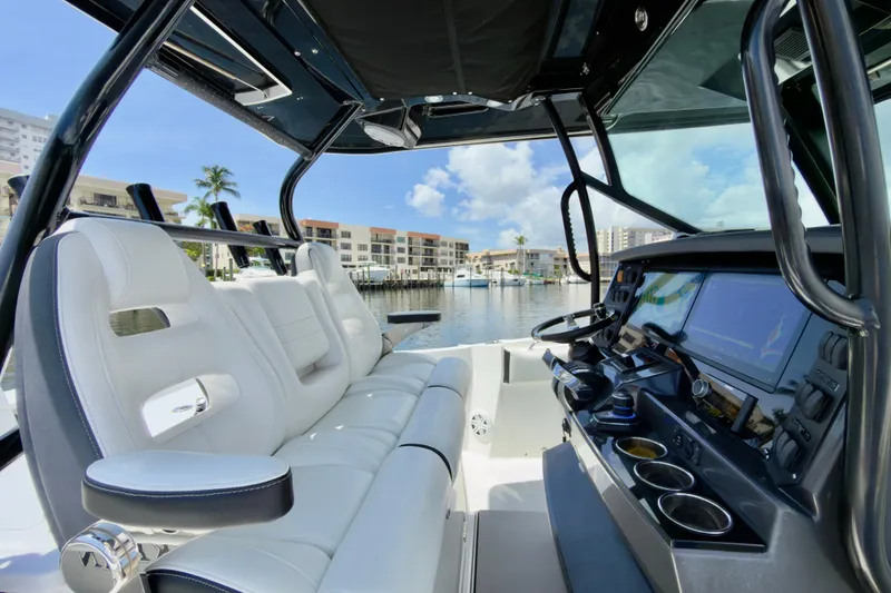 Slide: The Image of Interior view of 2021 Blackfin 332 CC boat with luxurious seating and modern dashboard. - 23