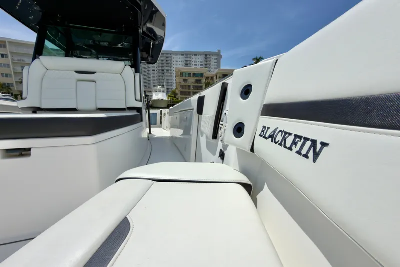 Slide: The Image of 2021 Blackfin 332 CC boat interior with sleek white seating and modern design. - 17
