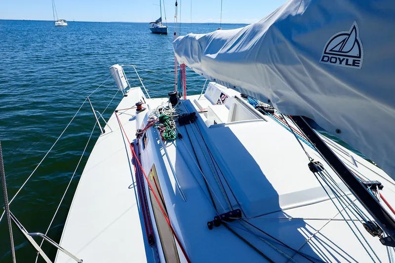 Slide: The Image of 2023 J Boats J/99 sailboat deck with Doyle sail cover on calm water. - 21