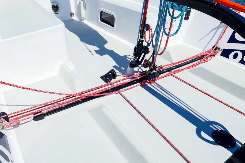 Slide: The Image of Deck view of 2023 J Boats J/99 sailboat with red and blue rigging lines. - 27