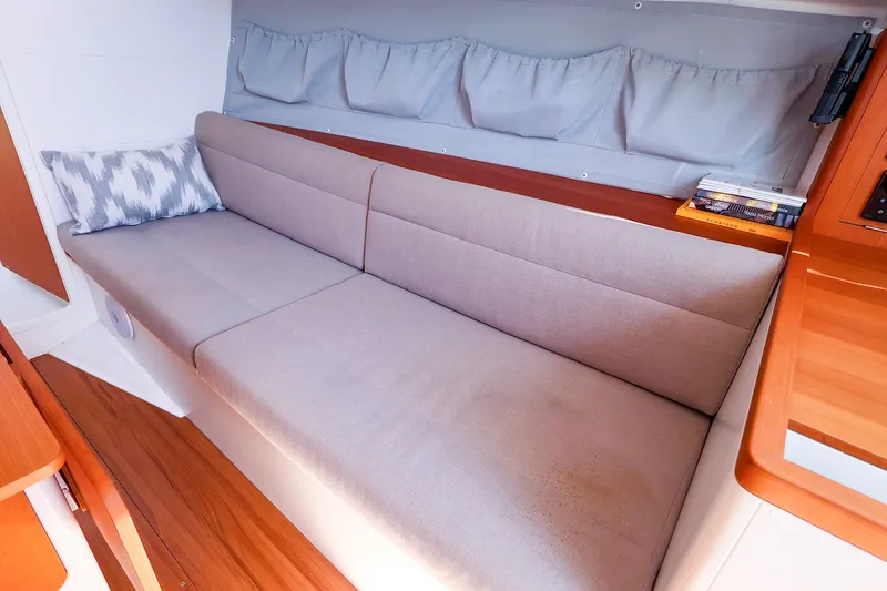 Slide: The Image of Interior of 2023 J Boats J/99 sailboat with cozy seating and wooden accents. - 45