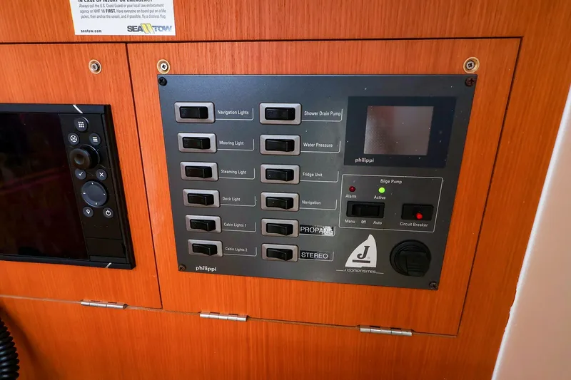 Slide: The Image of Control panel of a 2023 J Boats J/99 sailboat, featuring various switches and indicators. - 52