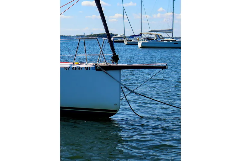 Slide: The Image of 2023 J Boats J/99 sailboat docked on calm water with other boats in background. - 14