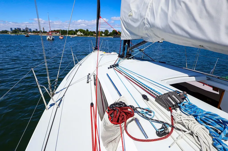 Slide: The Image of 2023 J Boats J/99 sailboat deck with ropes and rigging on a sunny day. - 13