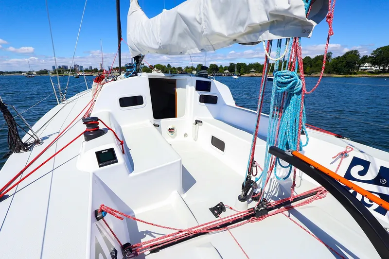 Slide: The Image of 2023 J Boats J/99 sailboat cockpit with ropes and winches on a sunny day. - 25