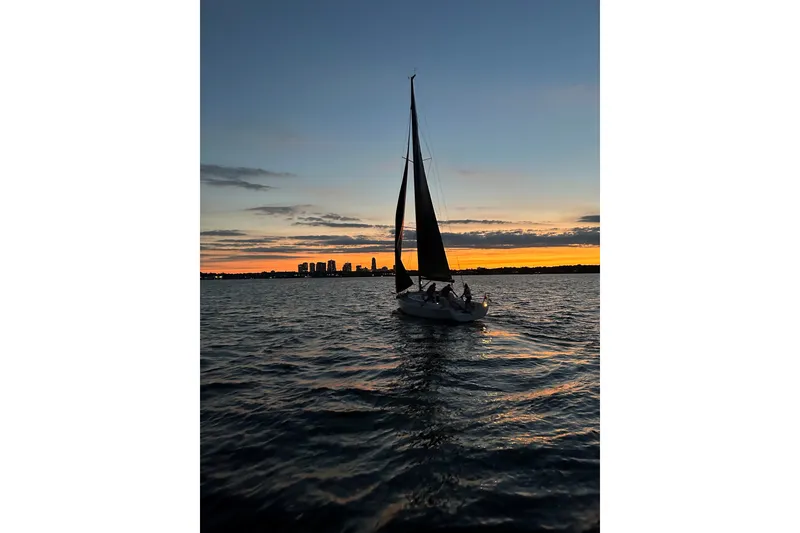 Slide: The Image of Sailboat J/99 by J Boats, 2023, silhouetted against a sunset on the water. - 7