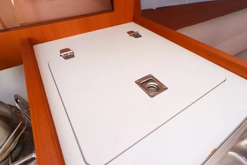 Slide: The Image of Interior view of 2023 J Boats J/99 yacht, featuring a sleek wooden cabinet. - 43