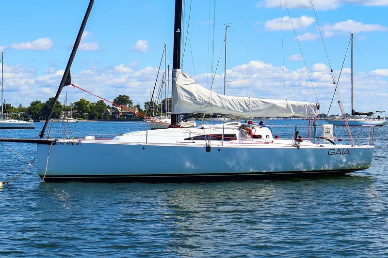 Slide: The Image of 2023 J Boats J/99 sailboat "GAIA" on calm water under a clear blue sky. - 4