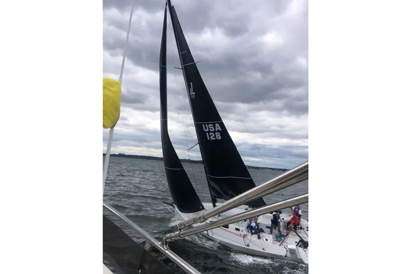 Slide: The Image of 2023 J Boats J/99 sailing on a cloudy day with crew onboard. - 9