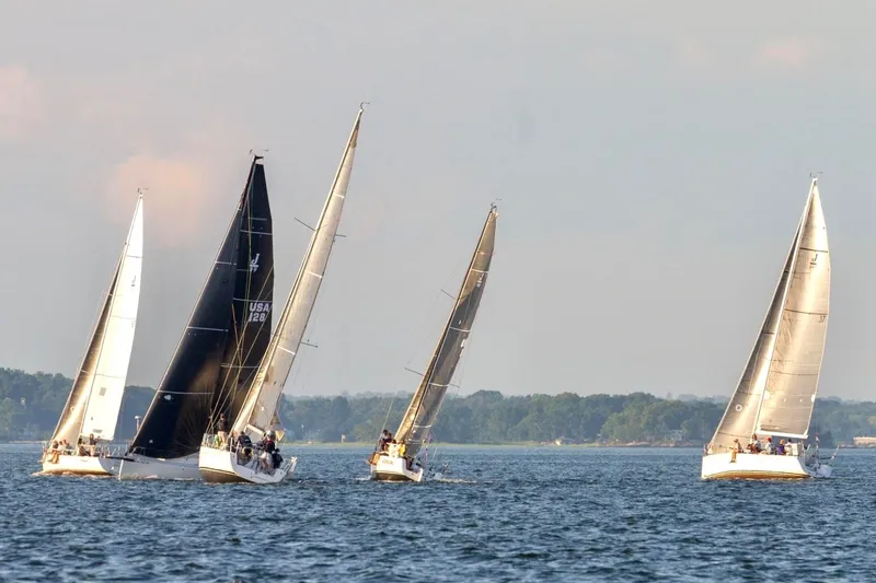 Slide: The Image of Sailboats racing on open water, featuring 2023 J Boats J/99 models. - 6