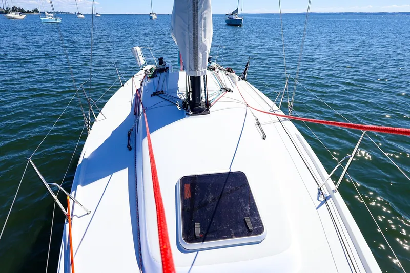 Slide: The Image of 2023 J Boats J/99 sailboat deck view on calm blue water. - 20