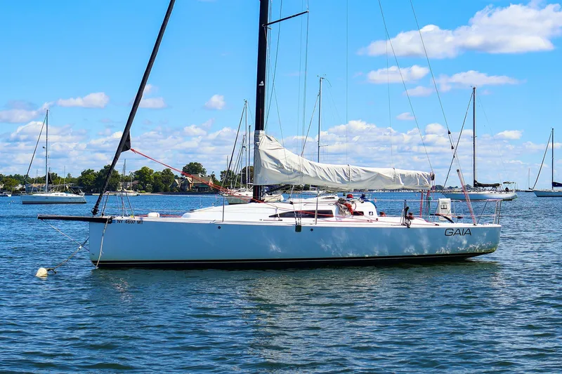 The Image of 2023 J Boats J/99 sailboat on calm water under a clear blue sky. - 0
