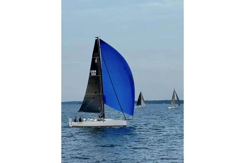 Slide: The Image of 2023 J Boats J/99 sailing with blue spinnaker on open water. - 8