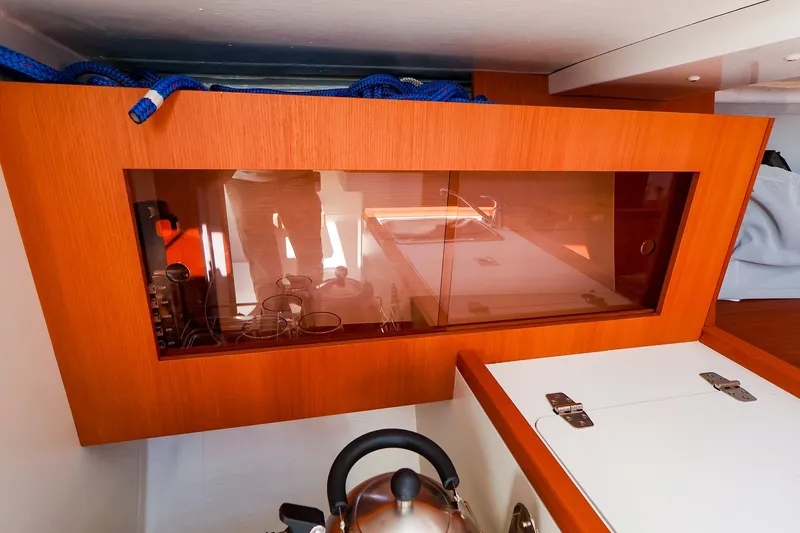 Slide: The Image of Interior of 2023 J Boats J/99 yacht, featuring a modern wooden cabinet and kettle. - 50