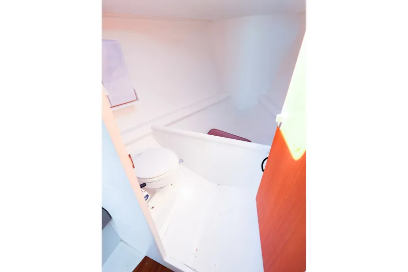 Slide: The Image of Interior view of 2023 J Boats J/99 sailboat's compact bathroom with toilet. - 48