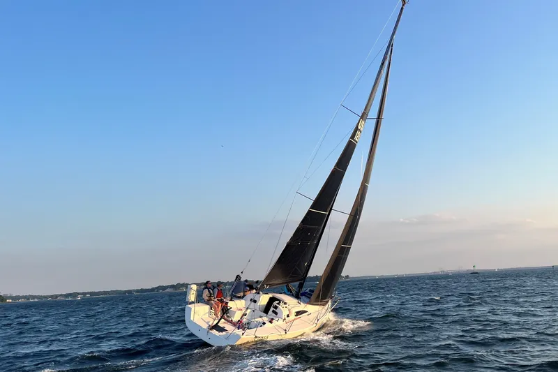 Slide: The Image of 2023 J Boats J/99 sailing on open water under clear blue sky. - 10