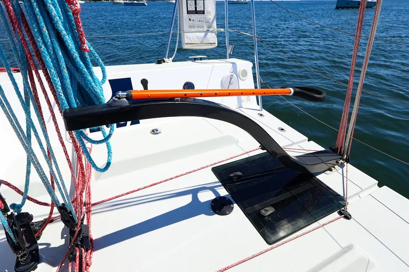 Slide: The Image of 2023 J Boats J/99 sailboat cockpit with ropes and tiller on a sunny day. - 26