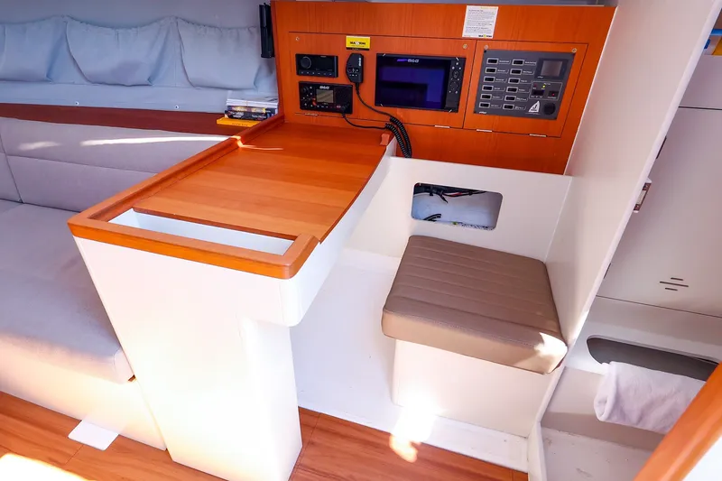Slide: The Image of Interior of 2023 J Boats J/99 sailboat featuring navigation station and seating area. - 42
