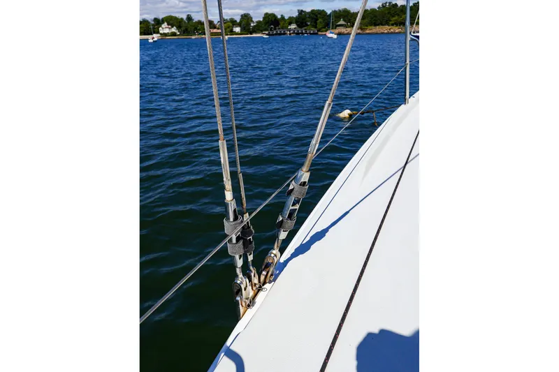 Slide: The Image of Close-up of 2023 J Boats J/99 sailboat rigging on calm water. - 16