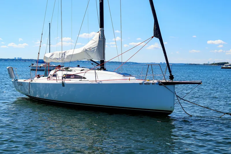 Slide: The Image of 2023 J Boats J/99 sailboat anchored on a sunny day in calm waters. - 2