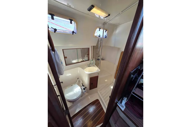 Slide: The Image of Bathroom interior of 1990 Canadian Sailcraft 34 yacht, featuring toilet, sink, and shower. - 19