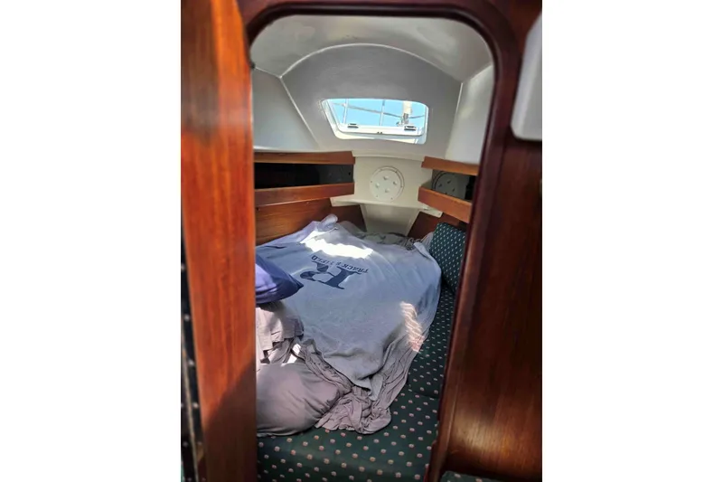 Slide: The Image of Cozy cabin interior of a 1990 Canadian Sailcraft 34 sailboat with wooden accents. - 18