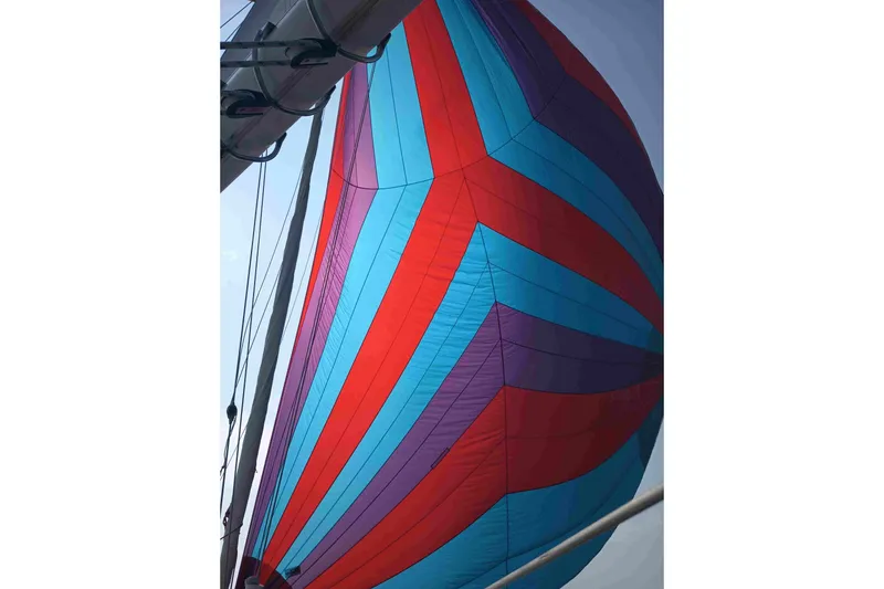 Slide: The Image of Colorful spinnaker sail on 1990 Canadian Sailcraft 34 yacht against clear sky. - 13