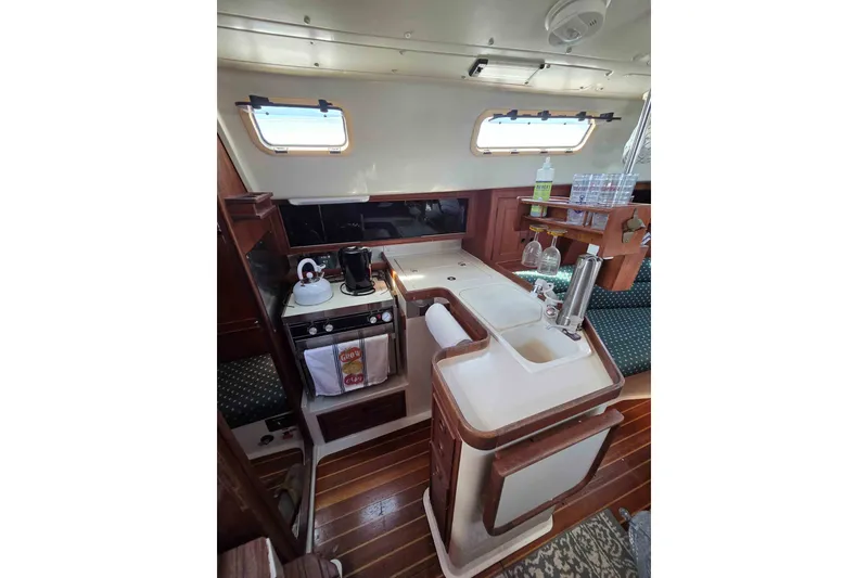 Slide: The Image of Interior of 1990 Canadian Sailcraft 34 sailboat with kitchen and wooden flooring. - 15