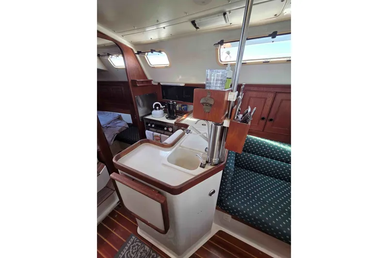 Slide: The Image of Interior of a 1990 Canadian Sailcraft 34 sailboat featuring a compact kitchen area. - 16
