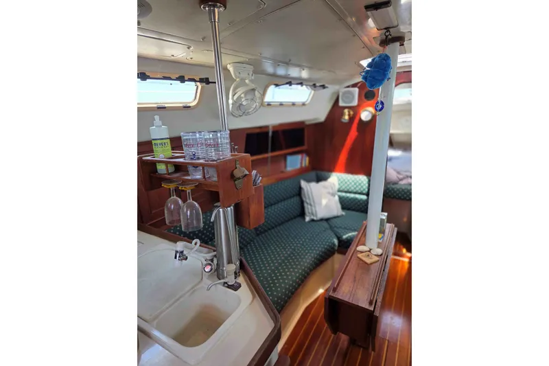 Slide: The Image of Interior of a 1990 Canadian Sailcraft 34 sailboat with cozy seating and kitchenette. - 17