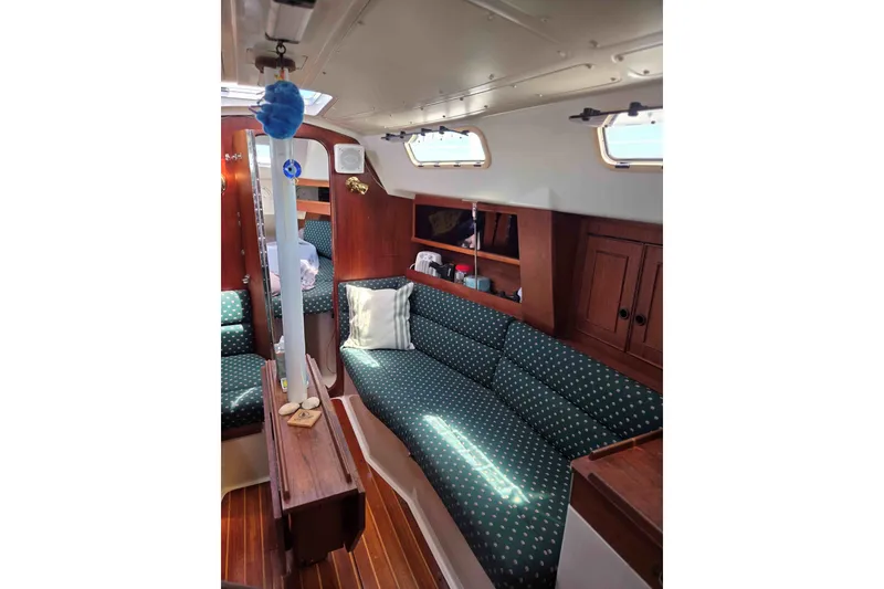 Slide: The Image of Interior of 1990 Canadian Sailcraft 34 sailboat with cozy seating and wooden cabinetry. - 20