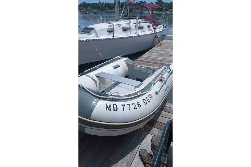 Slide: The Image of Inflatable dinghy docked beside a 1990 Canadian Sailcraft 34 sailboat. - 26
