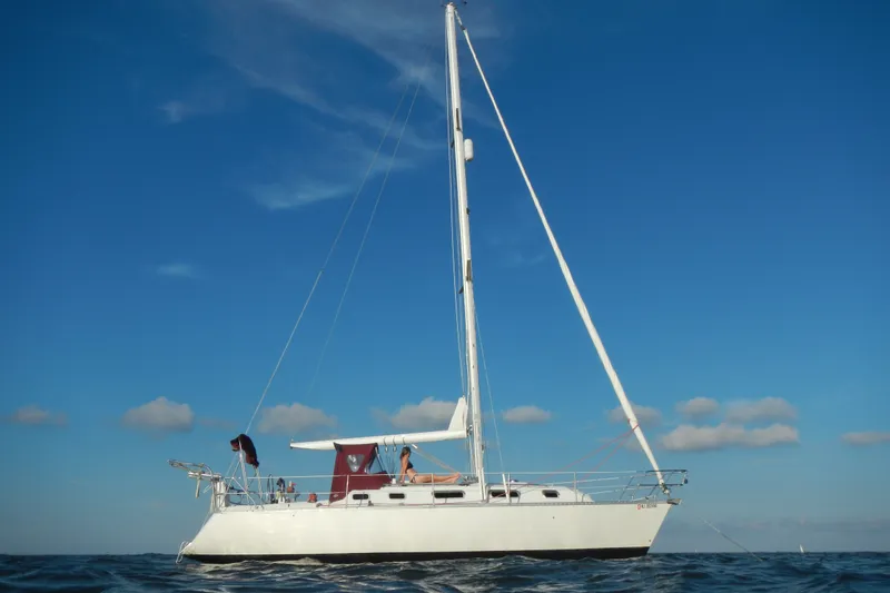 The Image of 1990 Canadian Sailcraft 34 sailboat on open water under clear blue sky. - 1