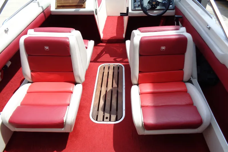 Slide: The Image of 1989 Stingray 172 SC boat interior with red and white seats and wooden flooring. - 12