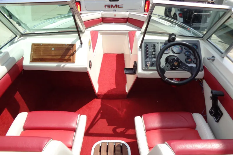 Slide: The Image of Interior of a 1989 Stingray 172 SC boat with red and white seating. - 26