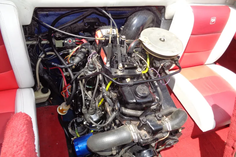 Slide: The Image of Engine compartment of a 1989 Stingray 172 SC boat with red and white seating. - 28