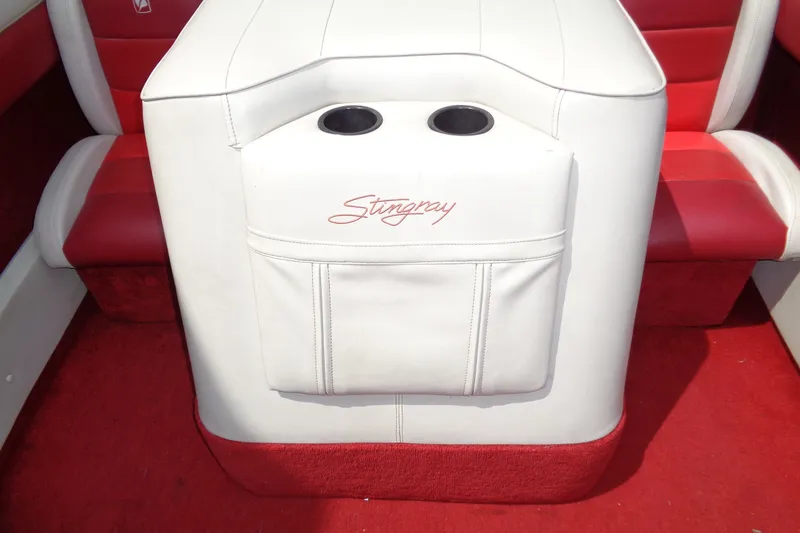Slide: The Image of Red and white interior of a 1989 Stingray 172 SC boat with cup holders. - 20
