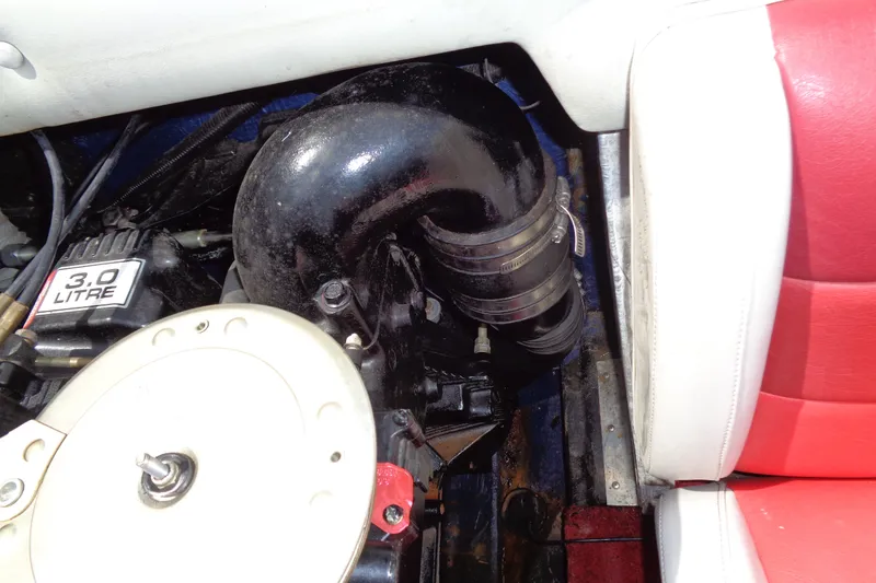 Slide: The Image of Engine compartment of a 1989 Stingray 172 SC boat, featuring a 3.0-liter engine. - 29