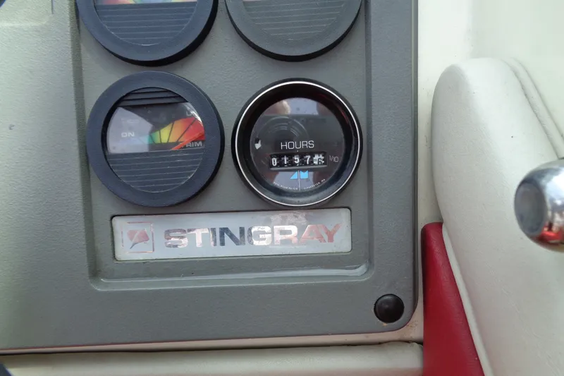 Slide: The Image of Dashboard of a 1989 Stingray 172 SC boat with hour meter and gauges. - 15