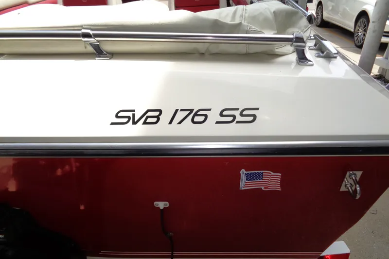 Slide: The Image of Red and white boat with "SVB 176 SS" text and American flag sticker. - 5