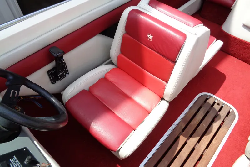 Slide: The Image of Red and white interior of a 1989 Stingray 172 SC boat with plush seating. - 18